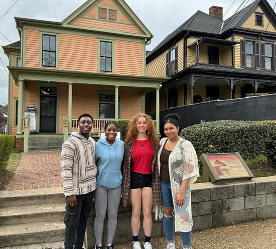 Aaliyah Foskolos (from left), Luka Galle, Sanayia Joefield and Michael Assim stand in front of Martin Luther King Jr.’s Atlanta birth home (on left), which is under restoration until 2025.